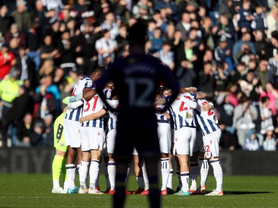 The Albion team in a huddle before the Oxford game at The Hawthorns