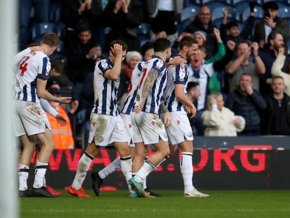 John Swift celebrates scoring against Oxford at The Hawthorns with team-mates