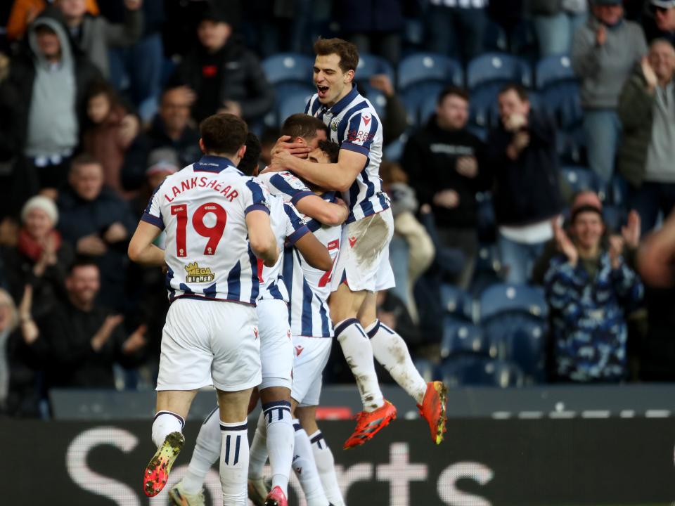 John Swift celebrates scoring against Oxford at The Hawthorns with team-mates