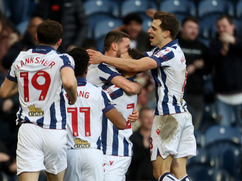 John Swift celebrates scoring against Oxford at The Hawthorns with team-mates
