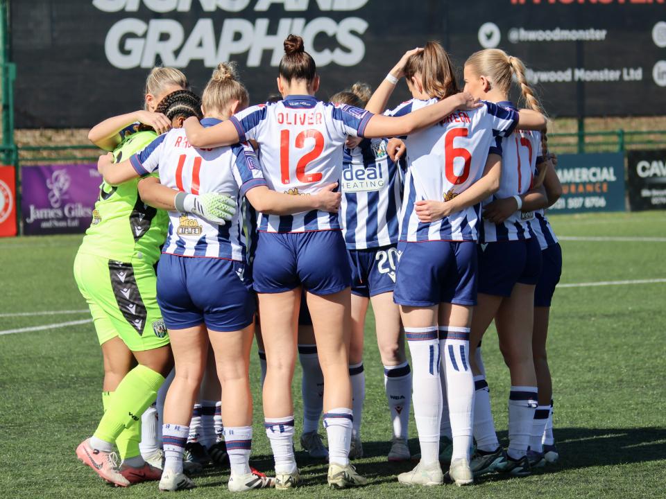 Albion Women in a team talk.