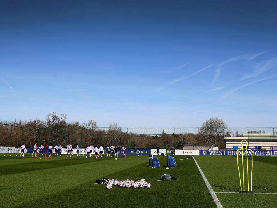 A general view of training in the sunlight with several players in shot