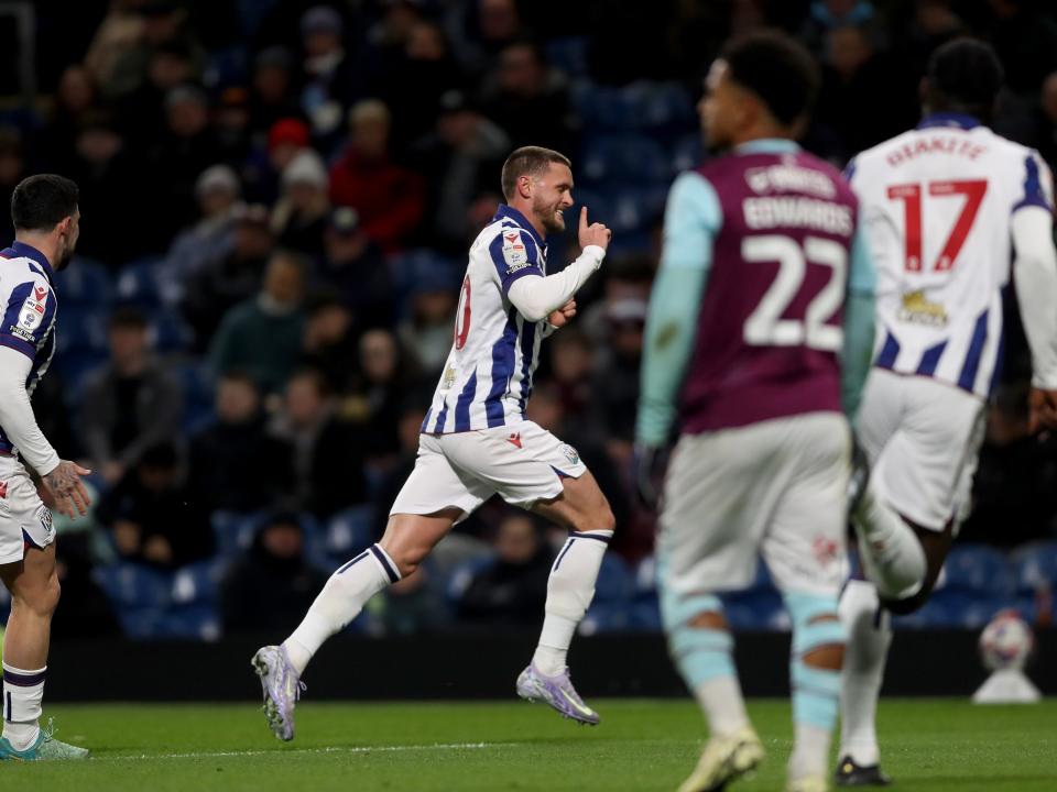John Swift runs off celebrating a free-kick goal at Burnley 