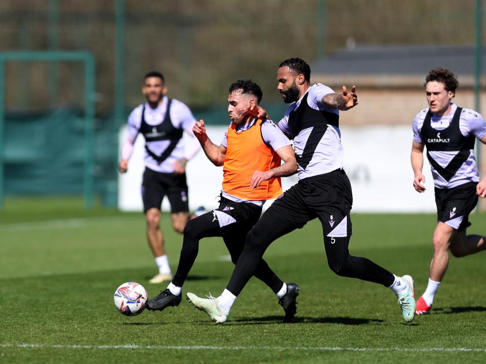 Tammer Bany and Kyle Bartley battling for the ball during training 