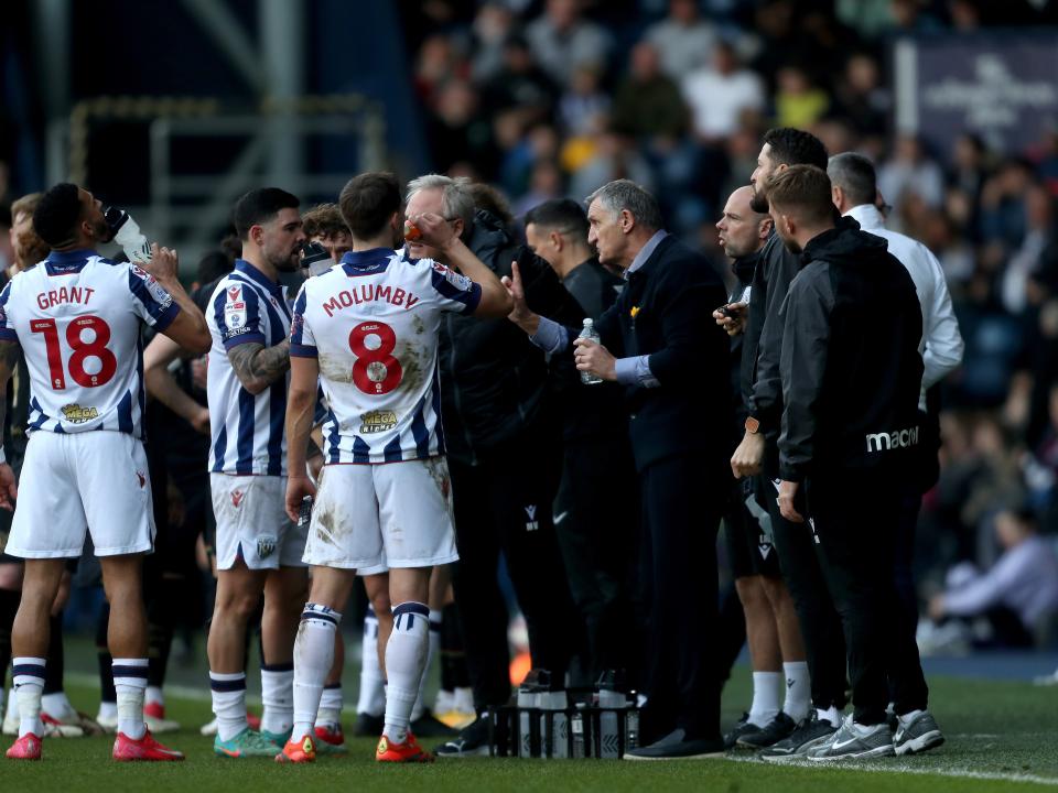 Tony Mowbray speaks to players on the side of the pitch during a stoppage against QPR 