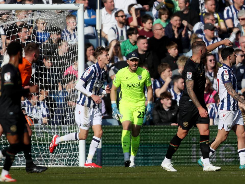 Joe Wildsmith wearing a cap and shouting during the game against QPR 