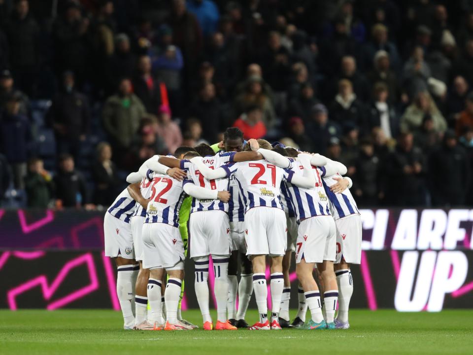 Albion team at Burnley in a pre-match huddle on the pitch