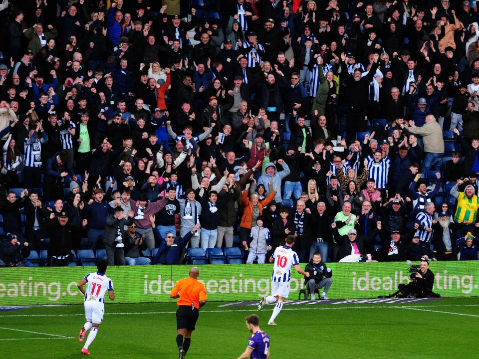 An image of John Swift celebrating with Albion fans after a goal