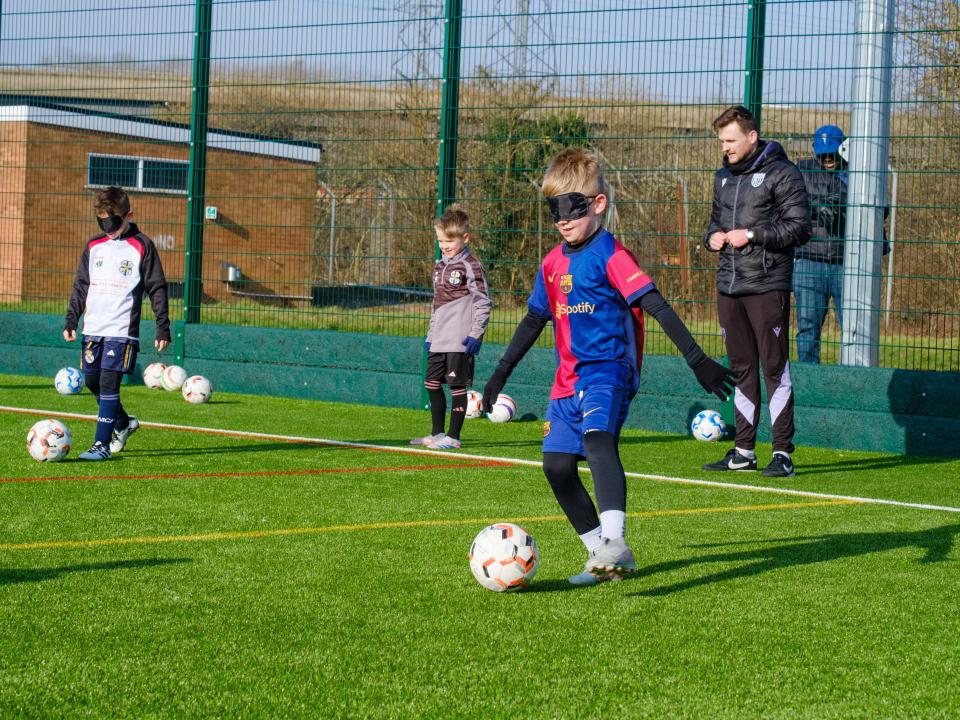 Participants take part in blind football activities.