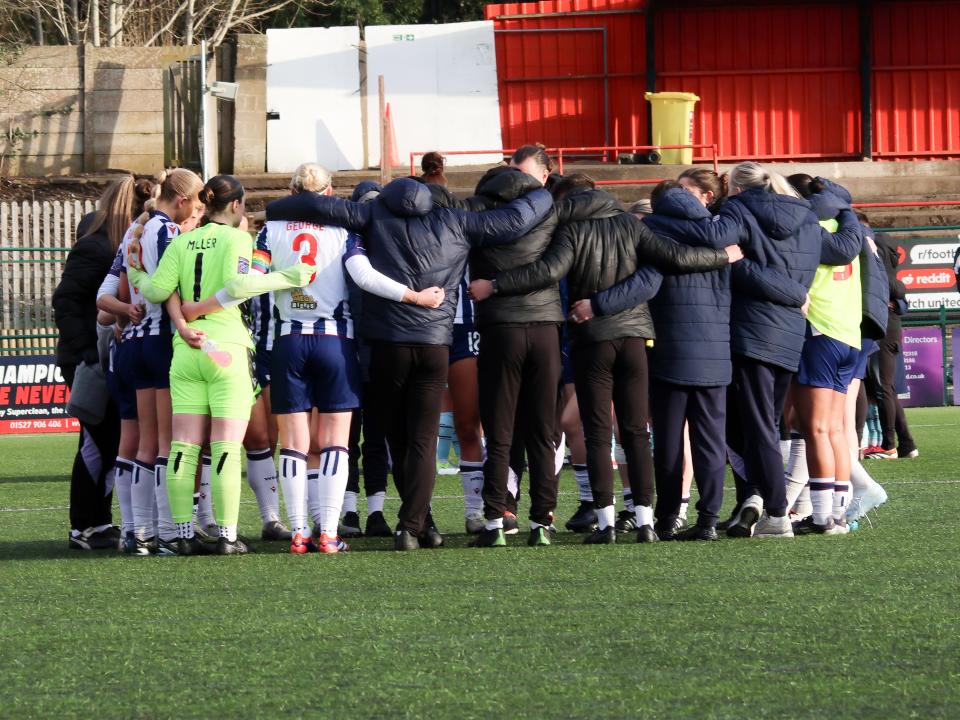 An image of the Albion Women squad in a huddle after their match against Burnley