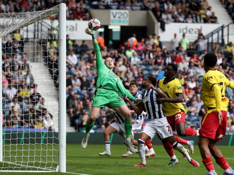 Watford's goalkeeper stretches to grasp the ball against Albion