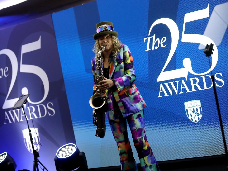 A saxophone player on stage at the end of season awards dinner