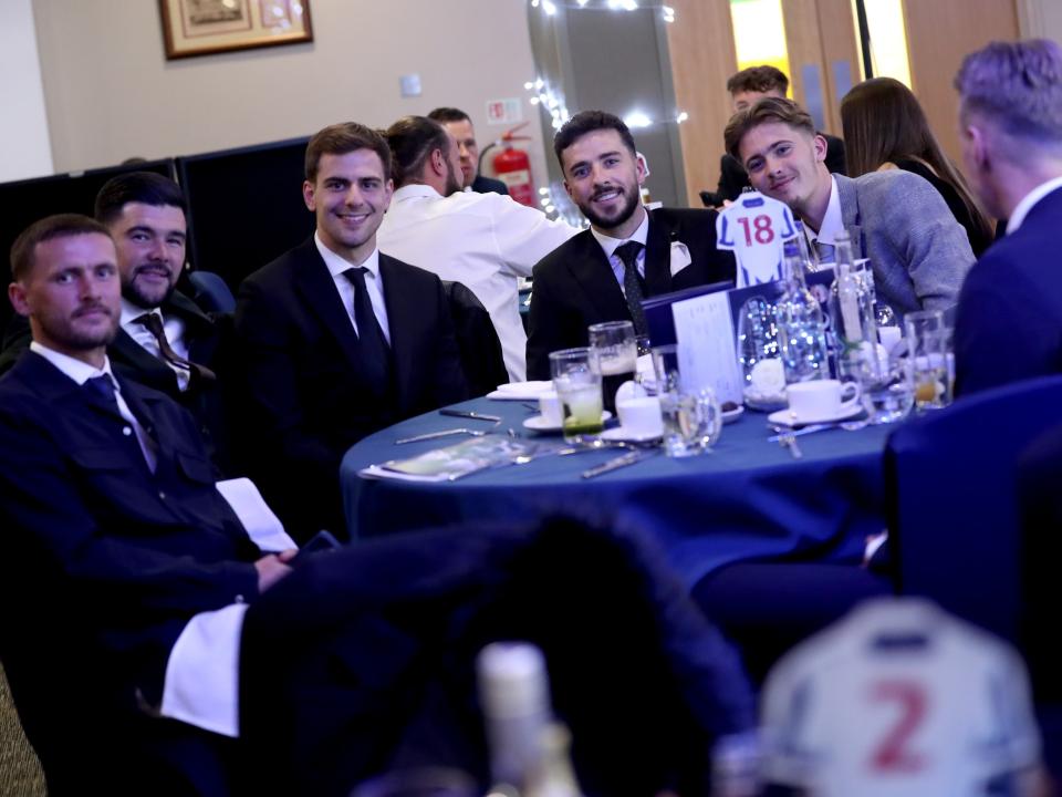 Several Albion players sat at a table at the end of season awards dinner posing for a photo