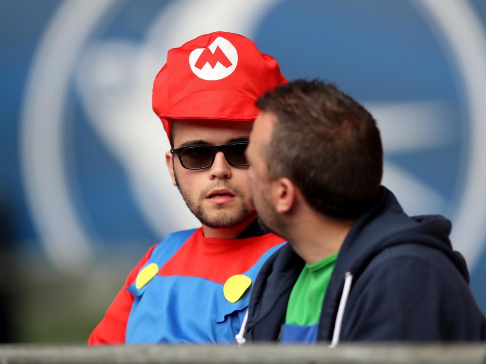 Albion fans in fancy dress in the away end at Cardiff