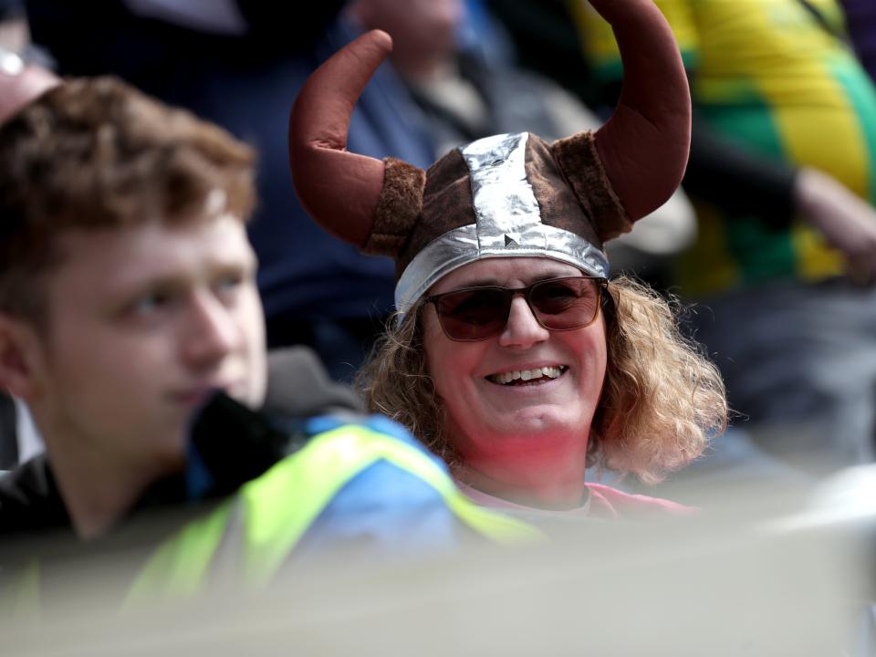 An Albion fan in the away end at Cardiff wearing a viking hat