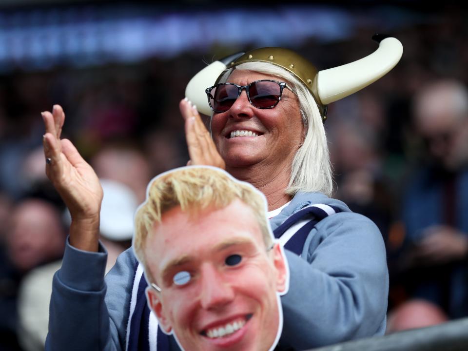 An Albion fan with a Torbjørn Heggem mask in the away end 