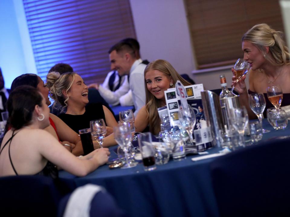Several Albion Women players sat at a table at the end of season awards dinner