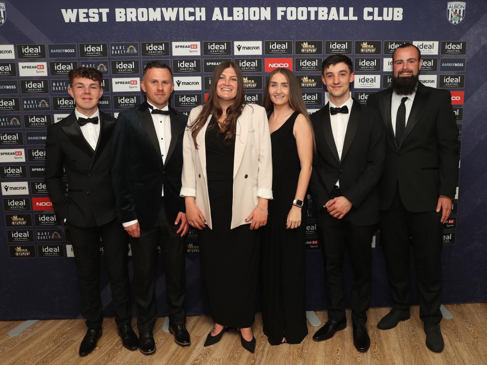 Siobhan Hodgetts-Still posing for a photo on stage with Albion Women staff at the end of season awards dinner