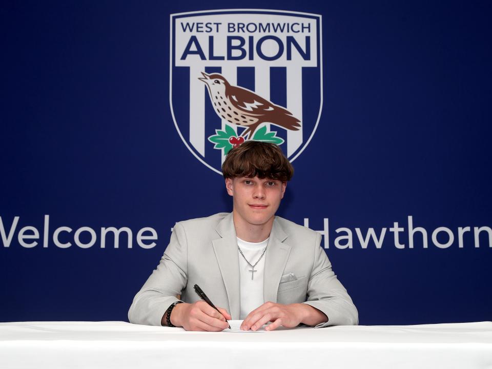 A photo of Albion scholar Alfie Round signing scholarship terms ahead of the 2025/26 season