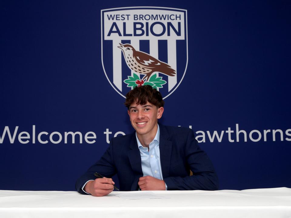 A photo of Albion scholar Theo Jackson signing scholarship terms ahead of the 2025/26 season