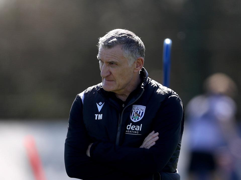Tony Mowbray watching training while stood in a black Albion coat 
