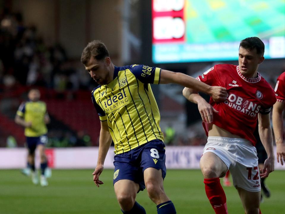 Jayson Molumby in action against Bristol City in the yellow and navy blue away kit 