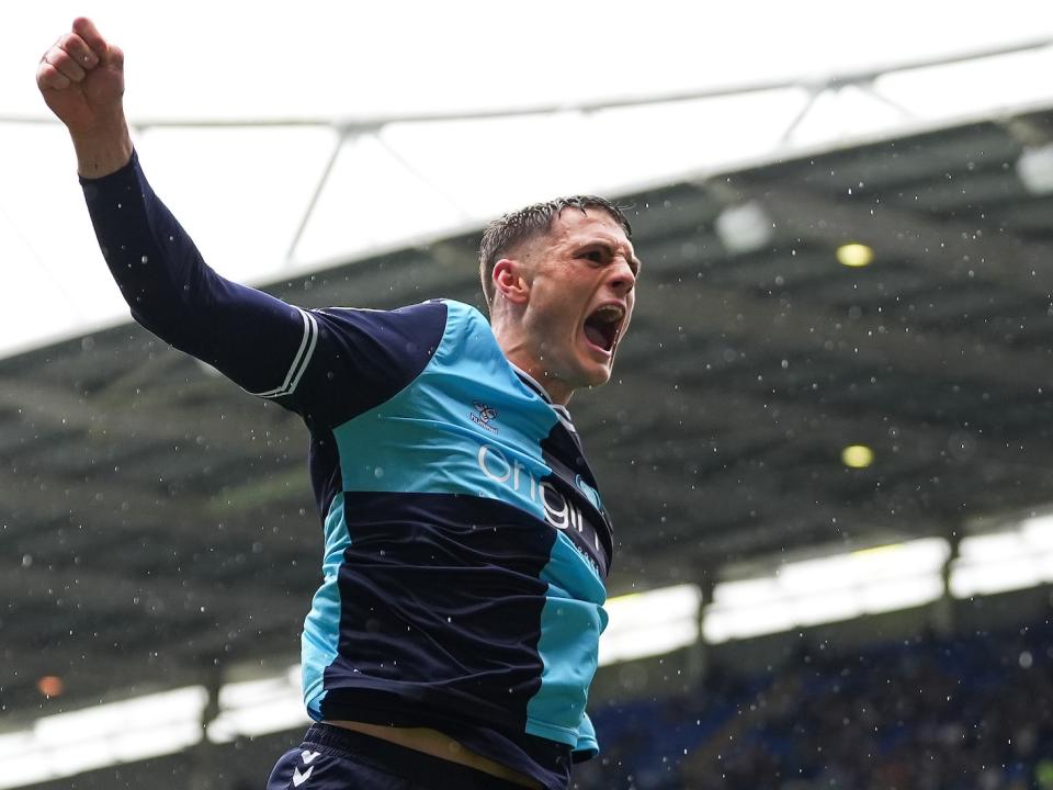 A photo of Caleb Taylor celebrating a goal for loan club Wycombe Wanderers, in their sky and navy blue home kit 