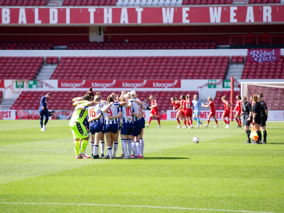 An image of Albion Women in a team huddle at The City Ground, Nottingham Forest