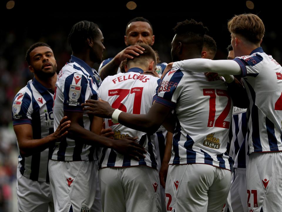 Tom Fellows celebrates with team-mates after scoring against Luton Town