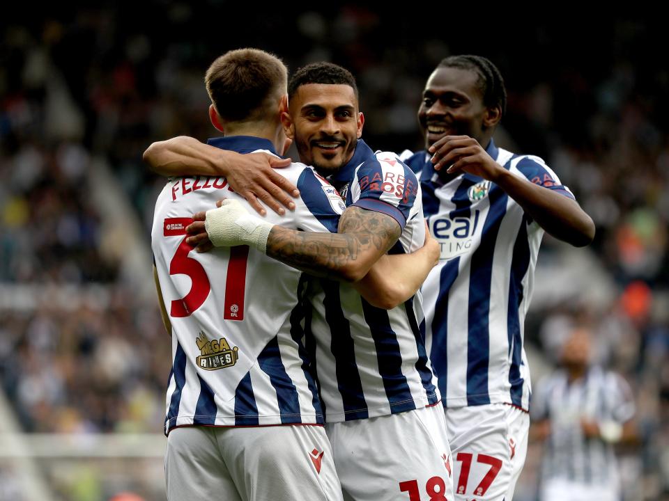 Tom Fellows celebrates with team-mates after scoring against Luton Town
