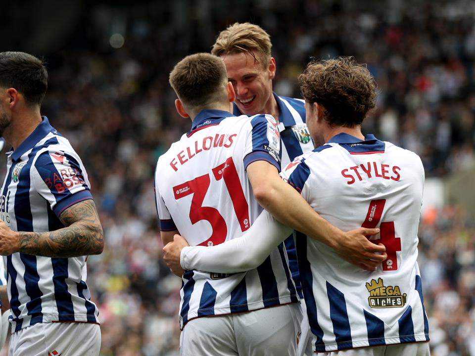 Tom Fellows celebrates with team-mates after scoring against Luton Town