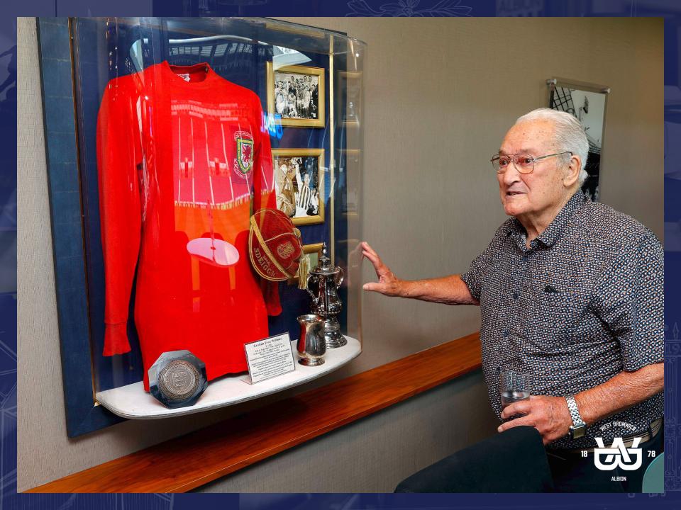 Graham Williams looking at his shirt outside The Graham Williams Suite