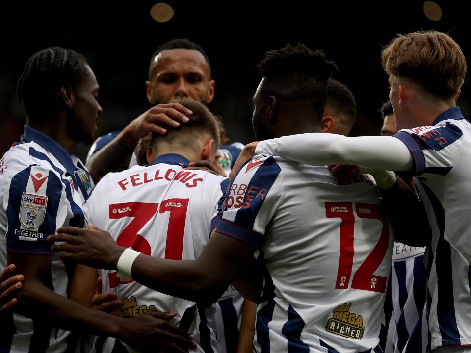 Tom Fellows celebrates with team-mates after scoring against Luton