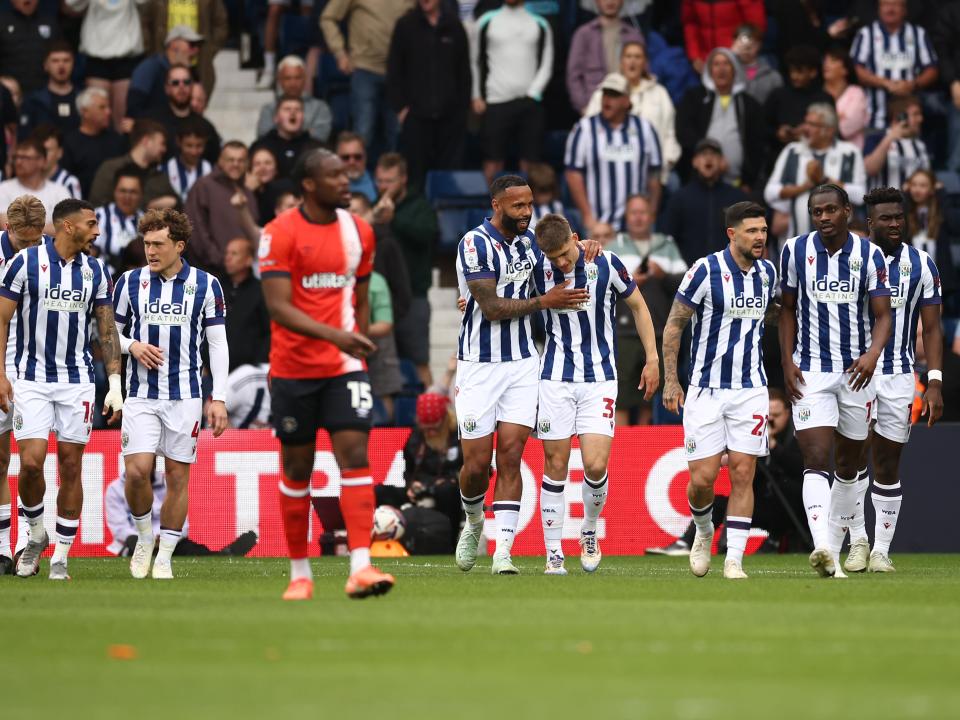 Tom Fellows celebrates with team-mates after scoring against Luton Town