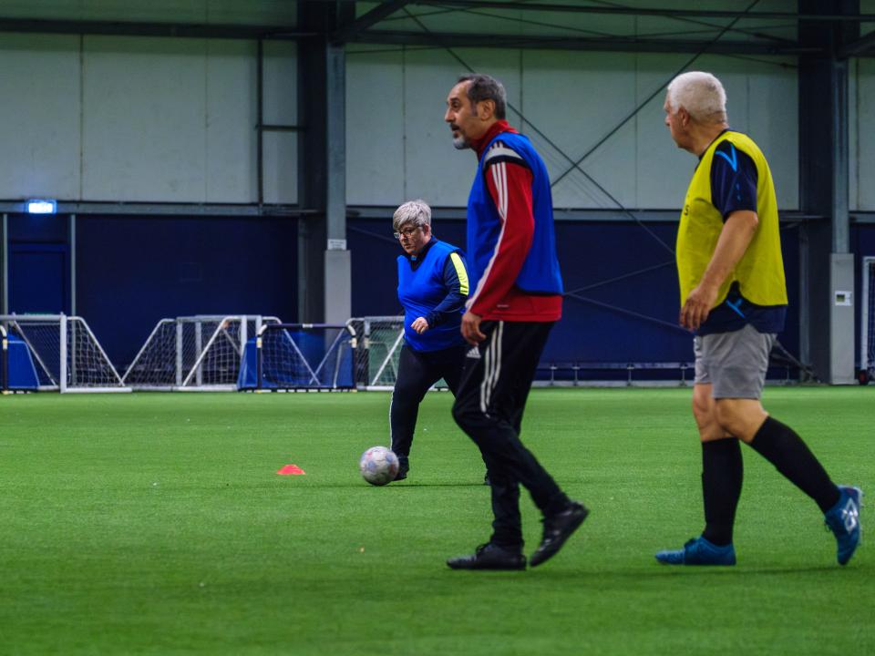Adult participants playing football.