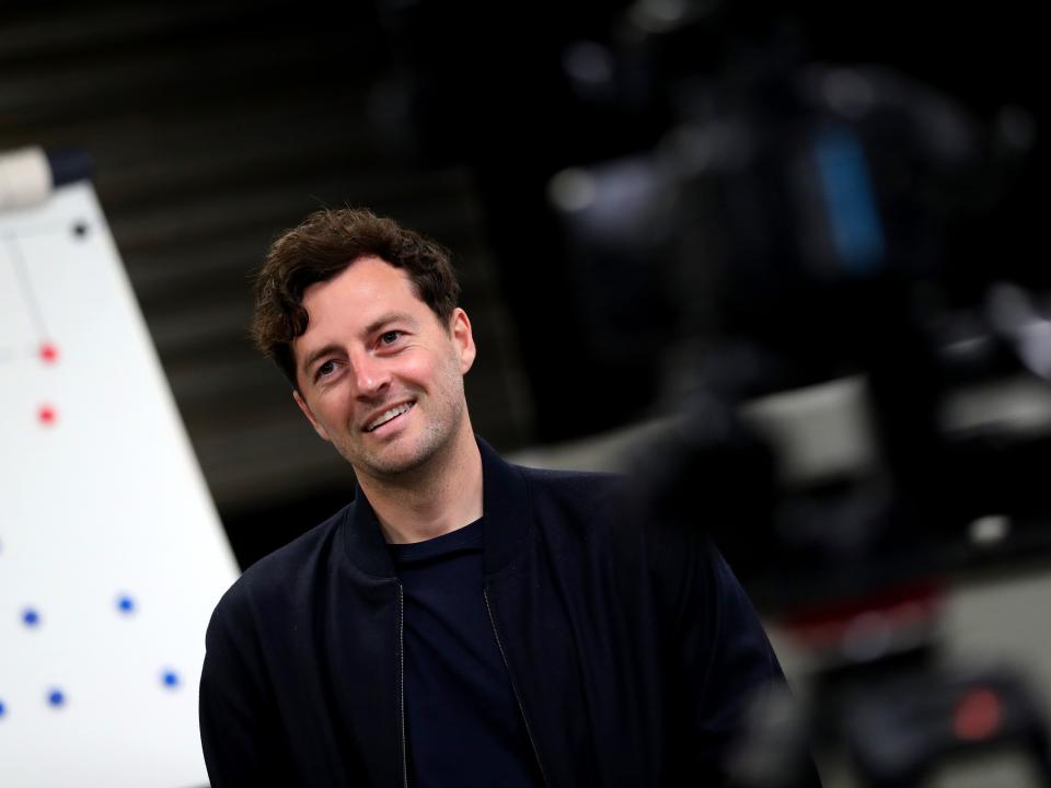 Ryan Mason smiling while sat in front of a tactics board 