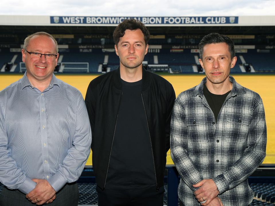 Mark Miles, Ryan Mason and Andrew Nestor posing for a photo at The Hawthorns with the West Stand behind them