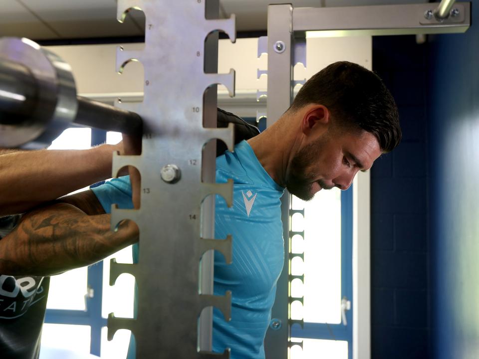 Alex Mowatt lifting weights in the gym
