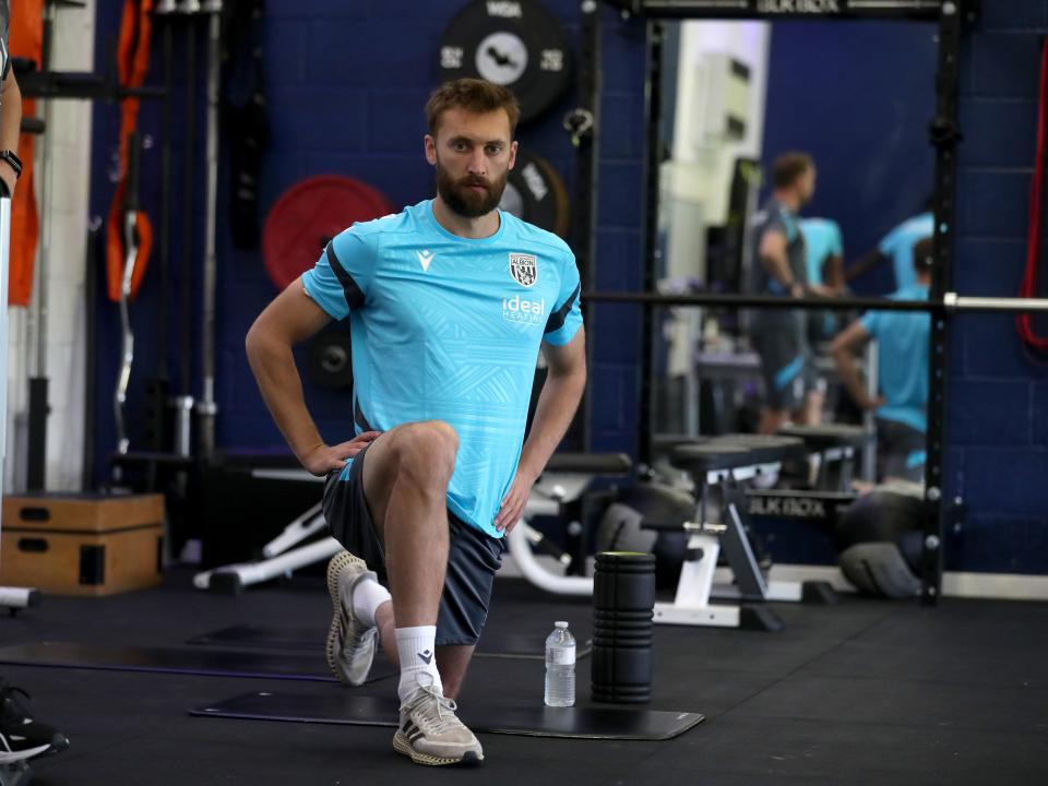 Nat Phillips stretching in the gym