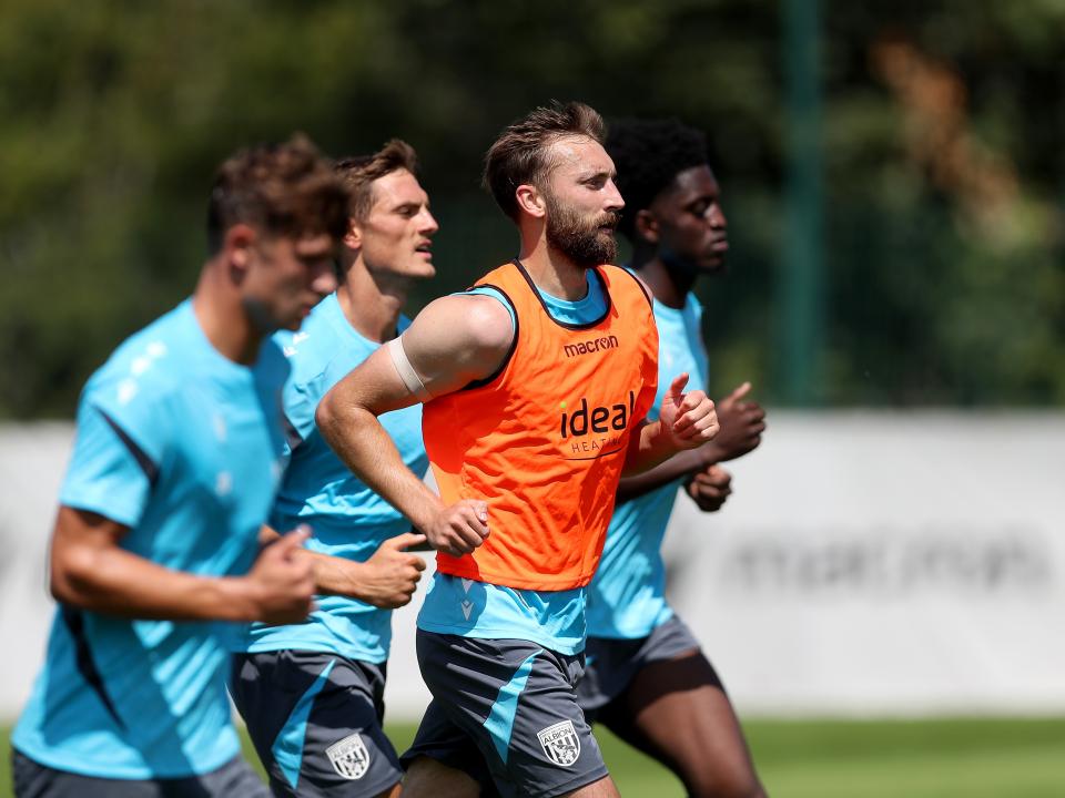 Nat Phillips and three team-mates running forward during a training session