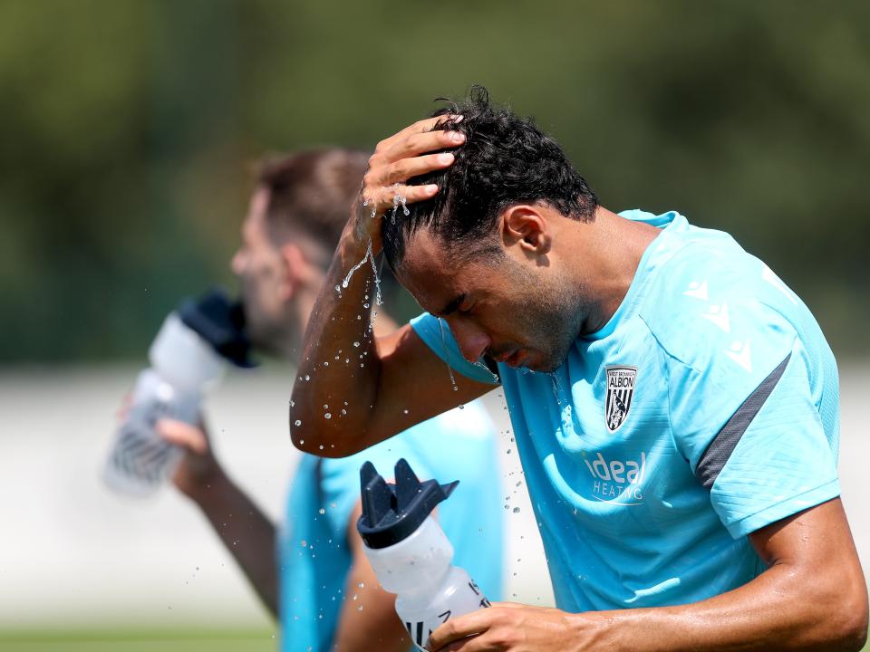 Gianluca Frabotta squirting water into his face during a break in the training session