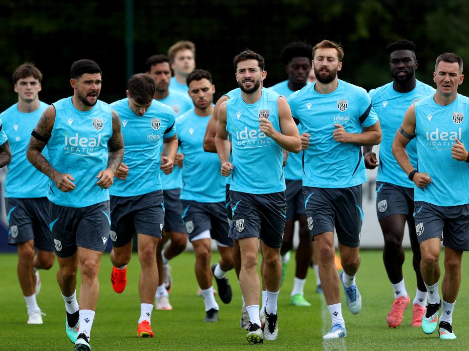 Several Albion players jogging during a training session