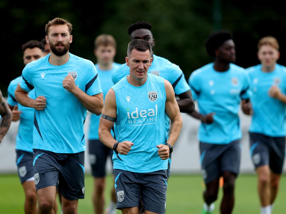 Several Albion players jogging during a training session