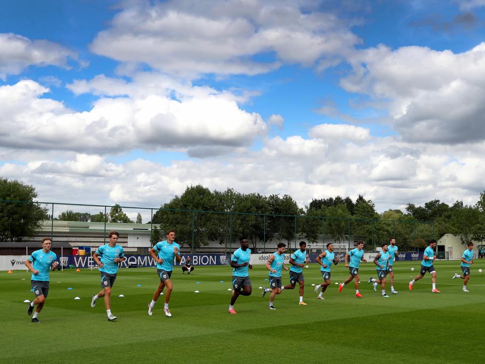 Several Albion players jogging during a training session