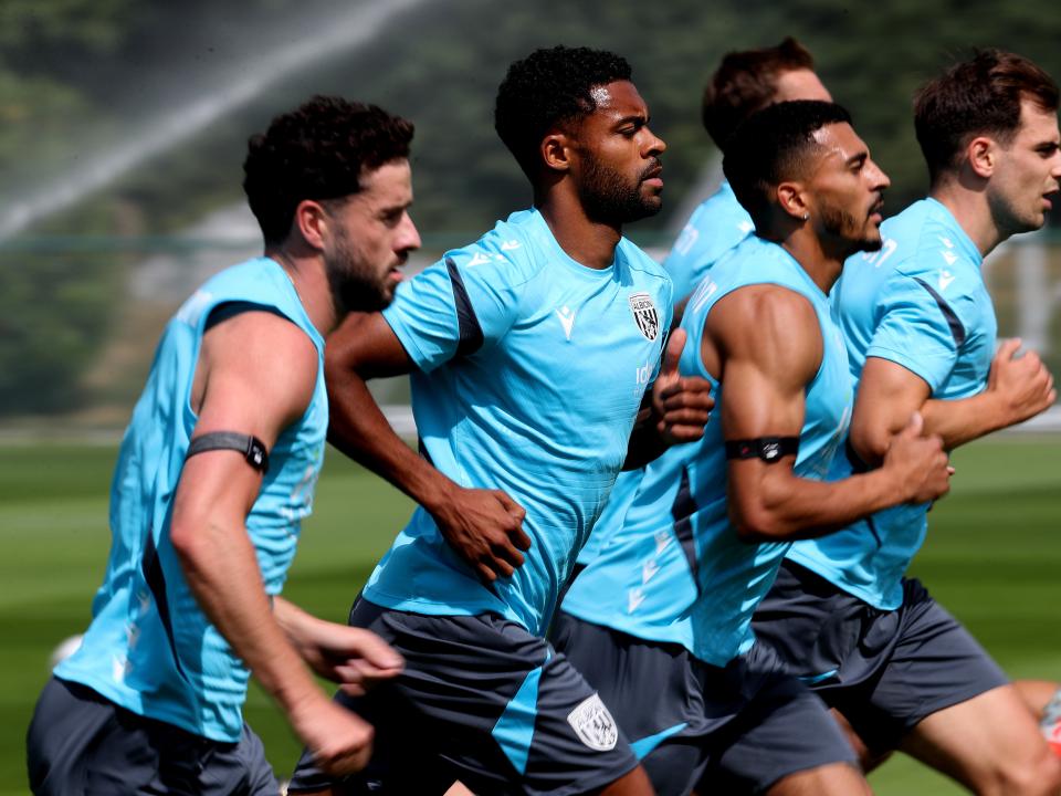 Several Albion players jogging during a training session