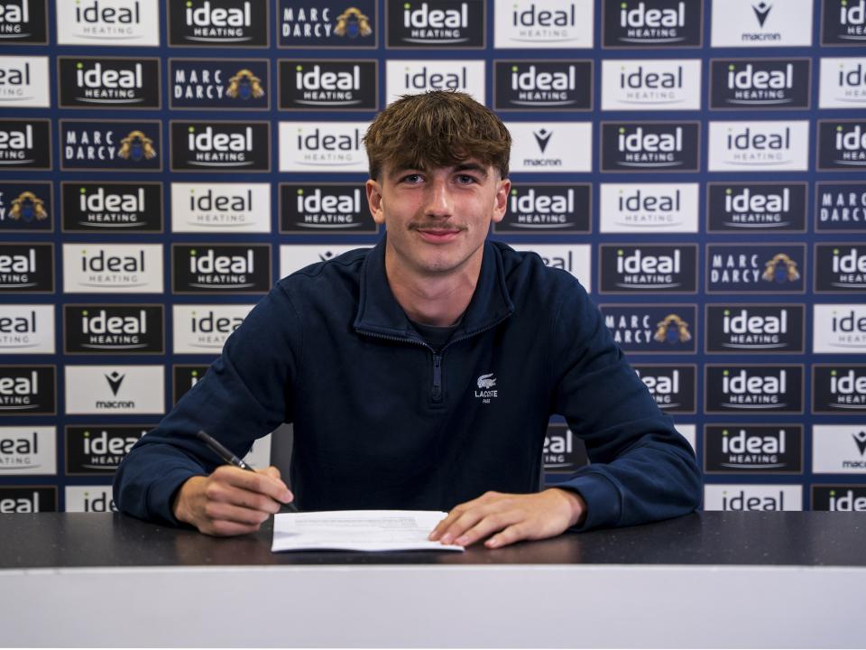 A photo of Albion youngster Alfie Maughan signing his first professional contract