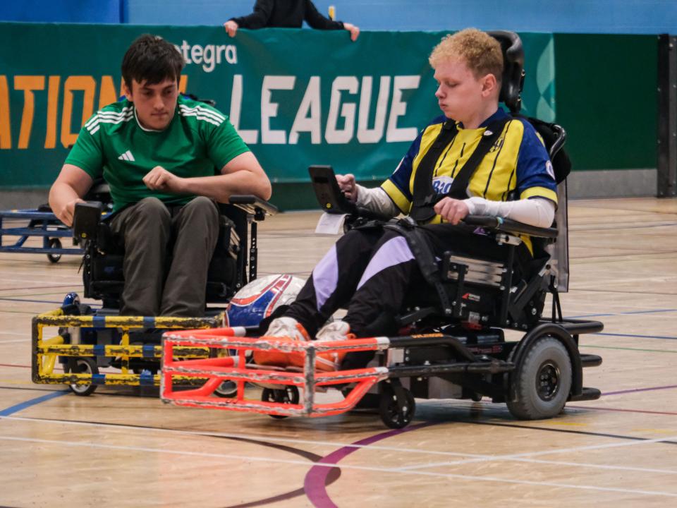 Dylan Kelsall tussles with a Leeds player for possession.