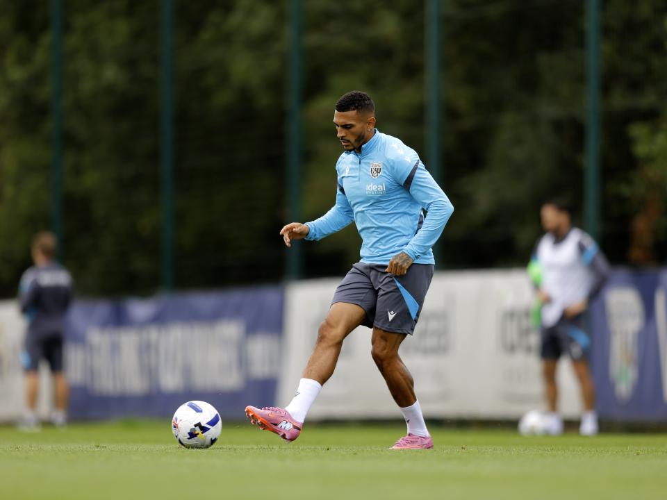 Karlan Grant passing the ball during training
