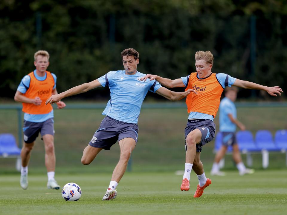 Caleb Taylor on the ball during a training session, under pressure from Ollie Bostock 