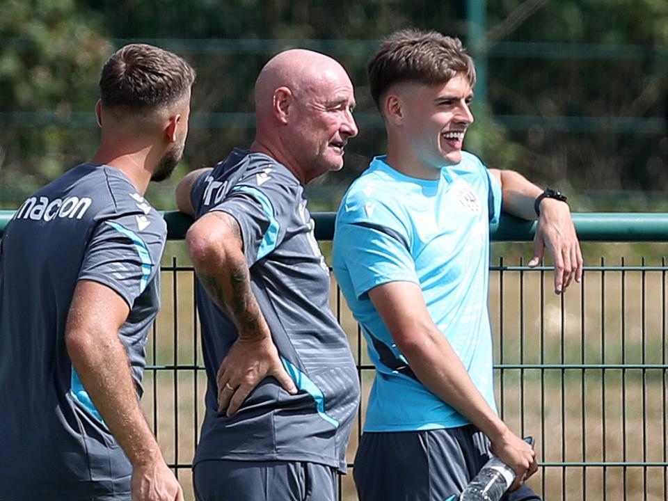 Tom Fellows chatting with two Albion staff members while watching the WBA v Port Vale pre-season friendly 